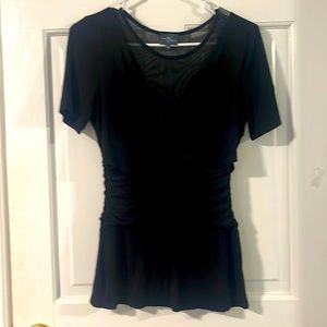 Pretty stylish black top with shear neckline. Woman’s Size XS. Like new.